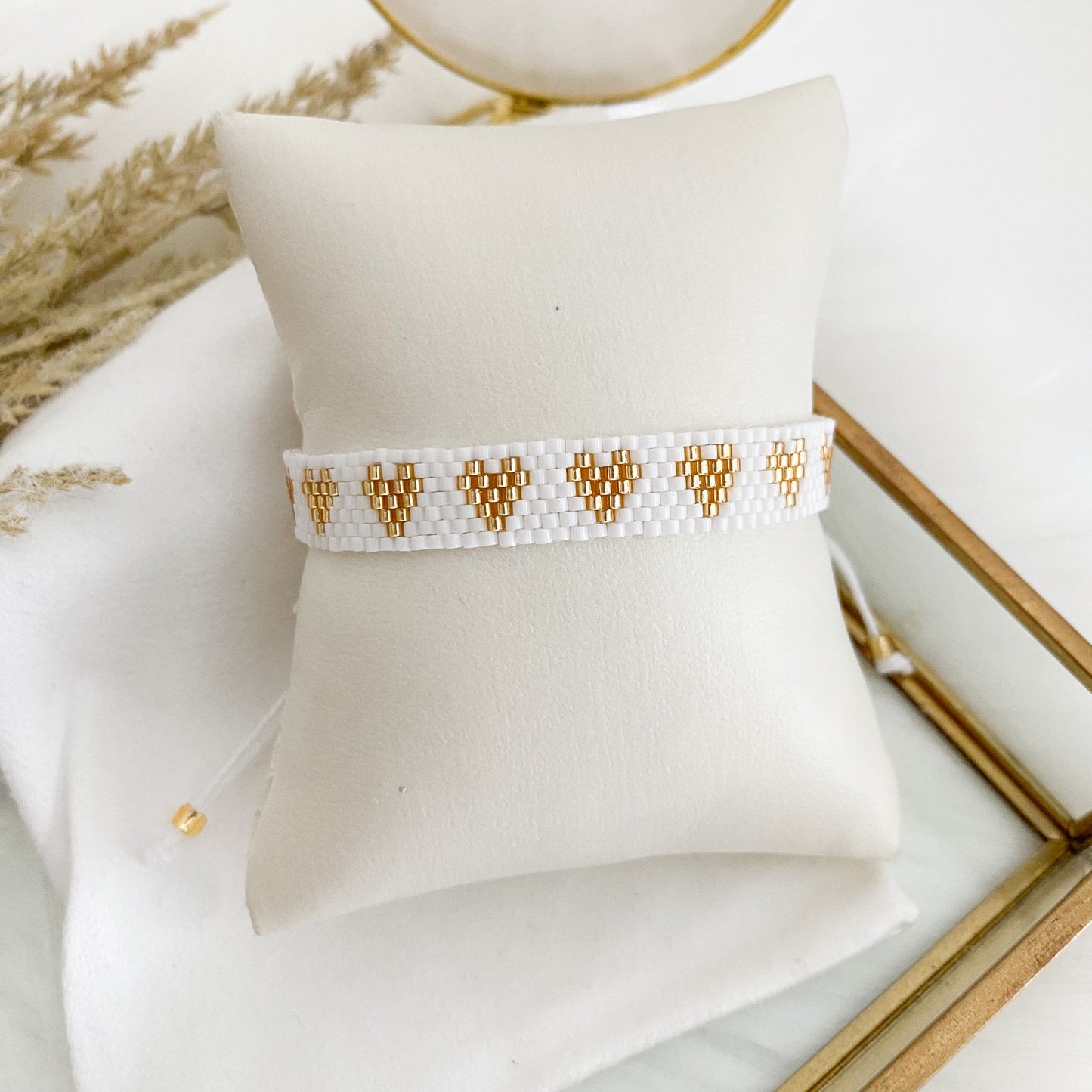 White bracelet with gold hearts