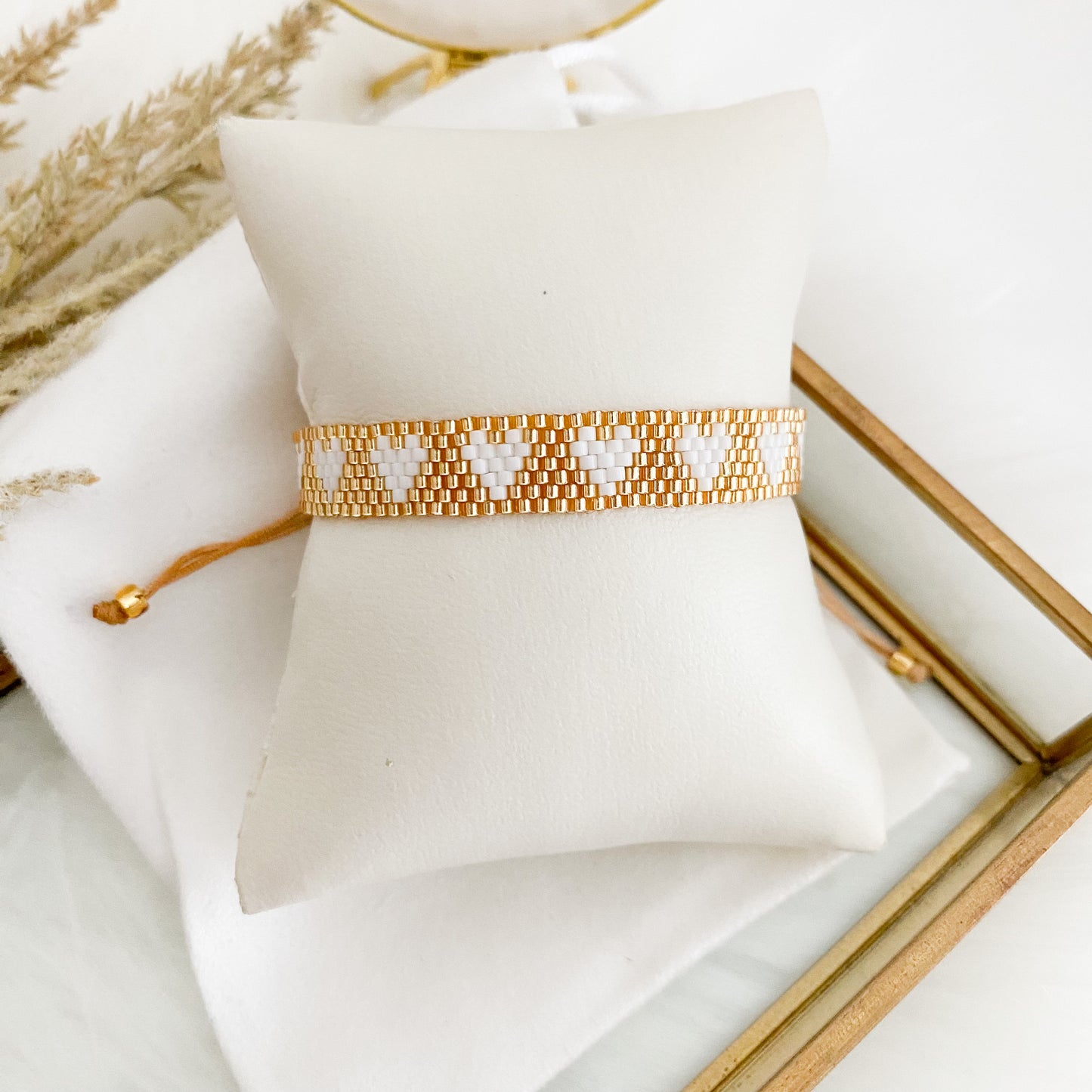 Golden bracelet with white hearts